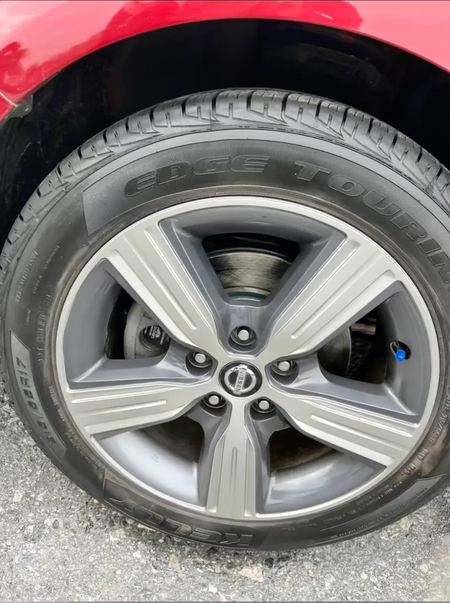 Same Nissan alloy wheel after curb rash repair and refinishing