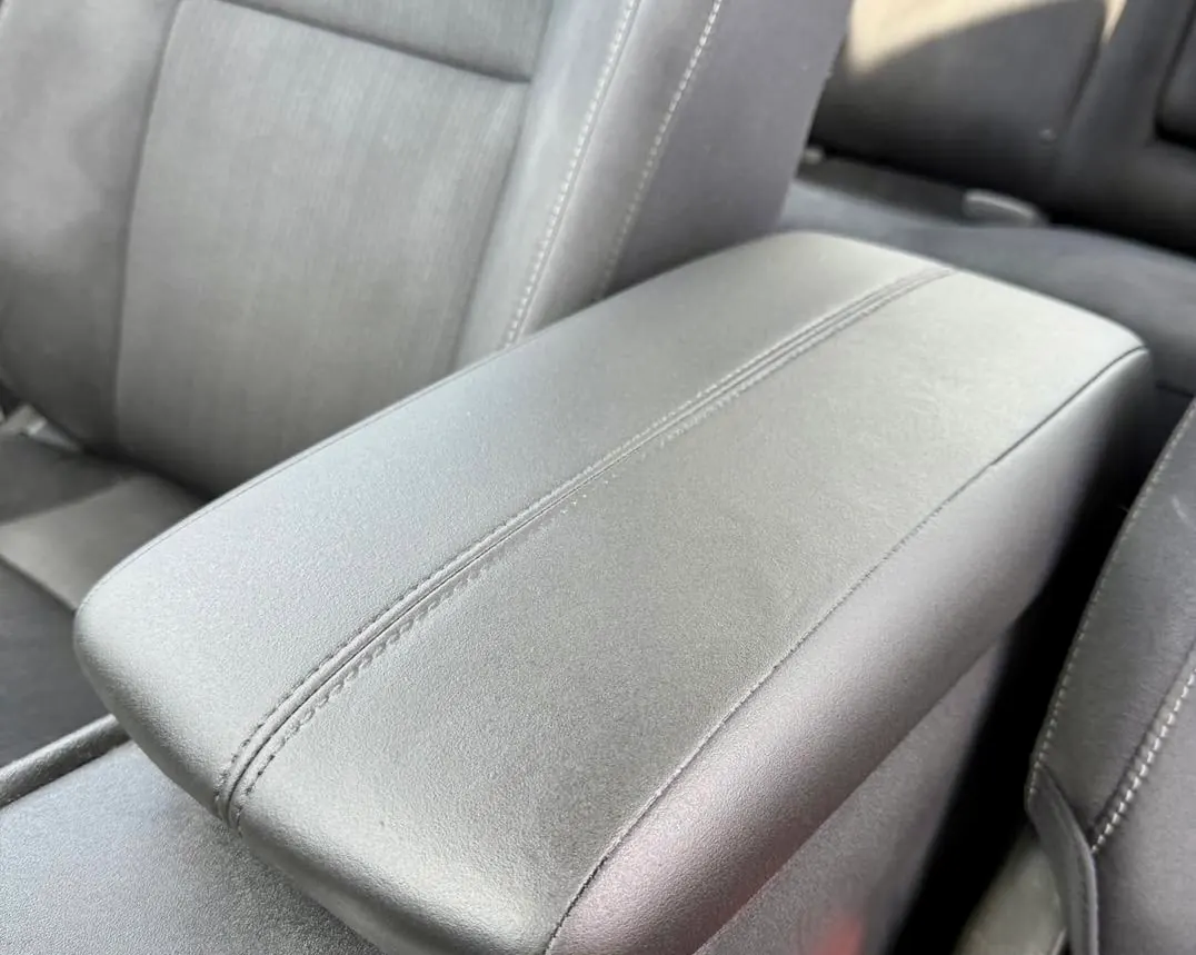 Black leather center console armrest and front seats