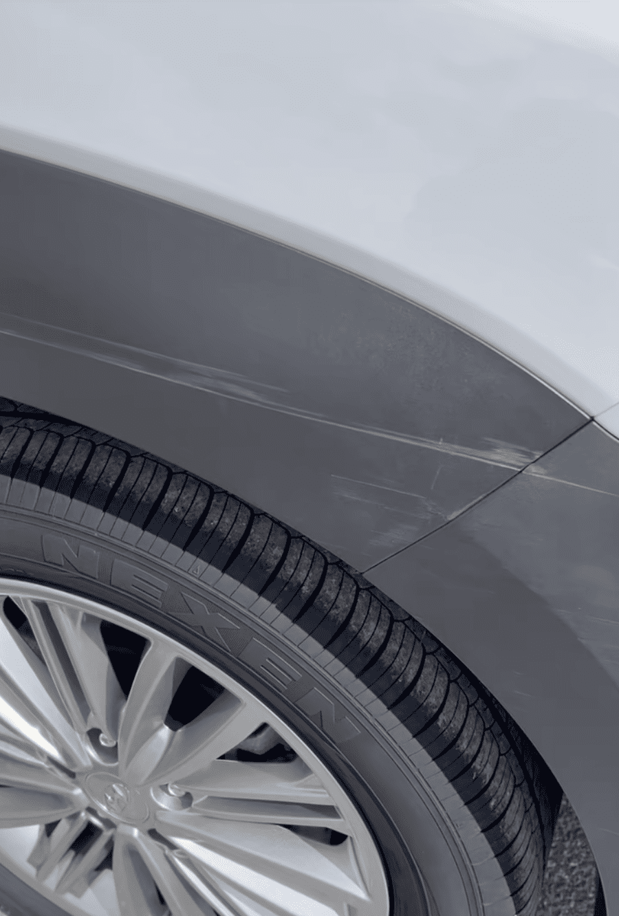 Scratches and scuffs on rear quarter panel before mobile paint repair