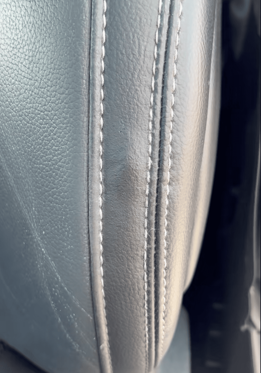 Restored leather console by sublet interior repair technician