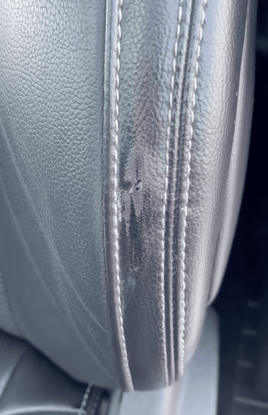 Damaged leather console before body shop interior sublet