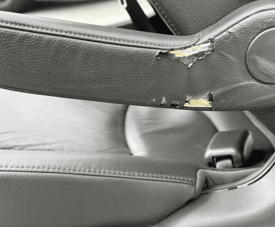 Damaged seat panel before fleet vehicle reconditioning