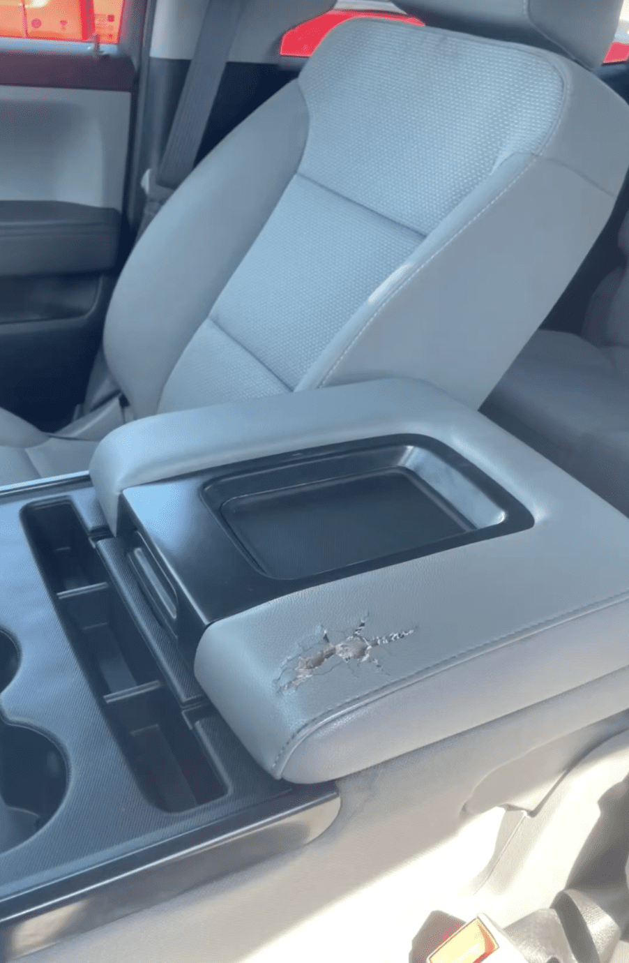Damaged console lid before fleet vehicle repair service