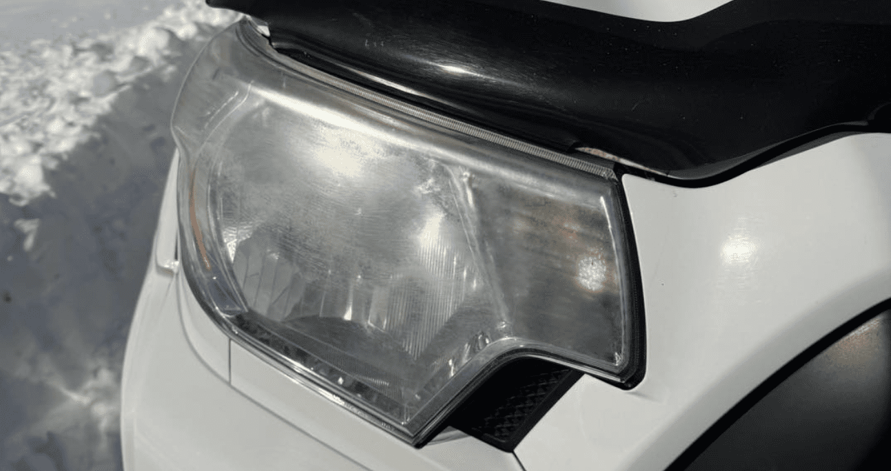 Yellowed foggy headlight lens before mobile restoration service