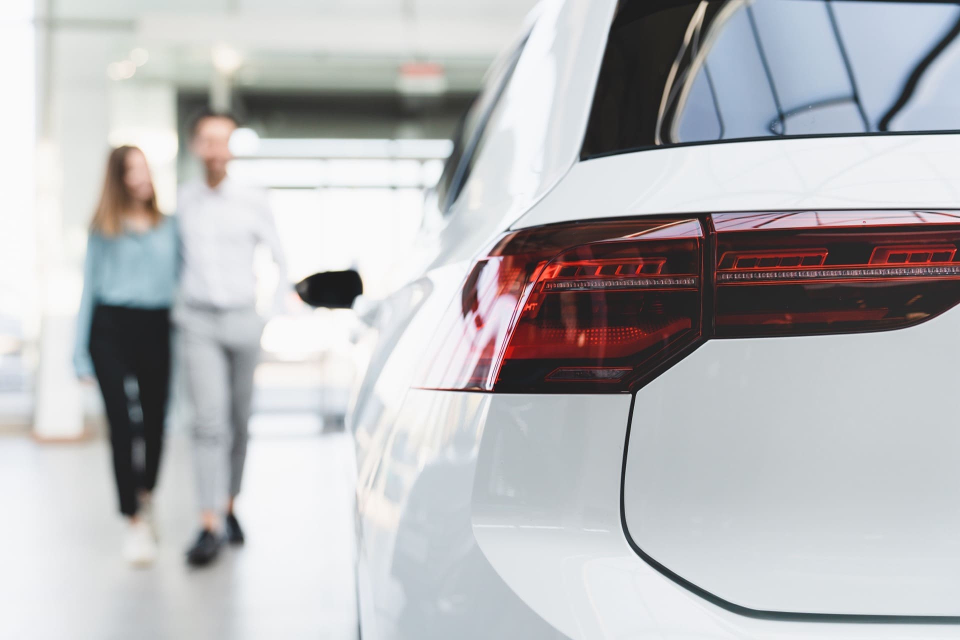 Couple inspecting vehicles at Philadelphia area car dealership
