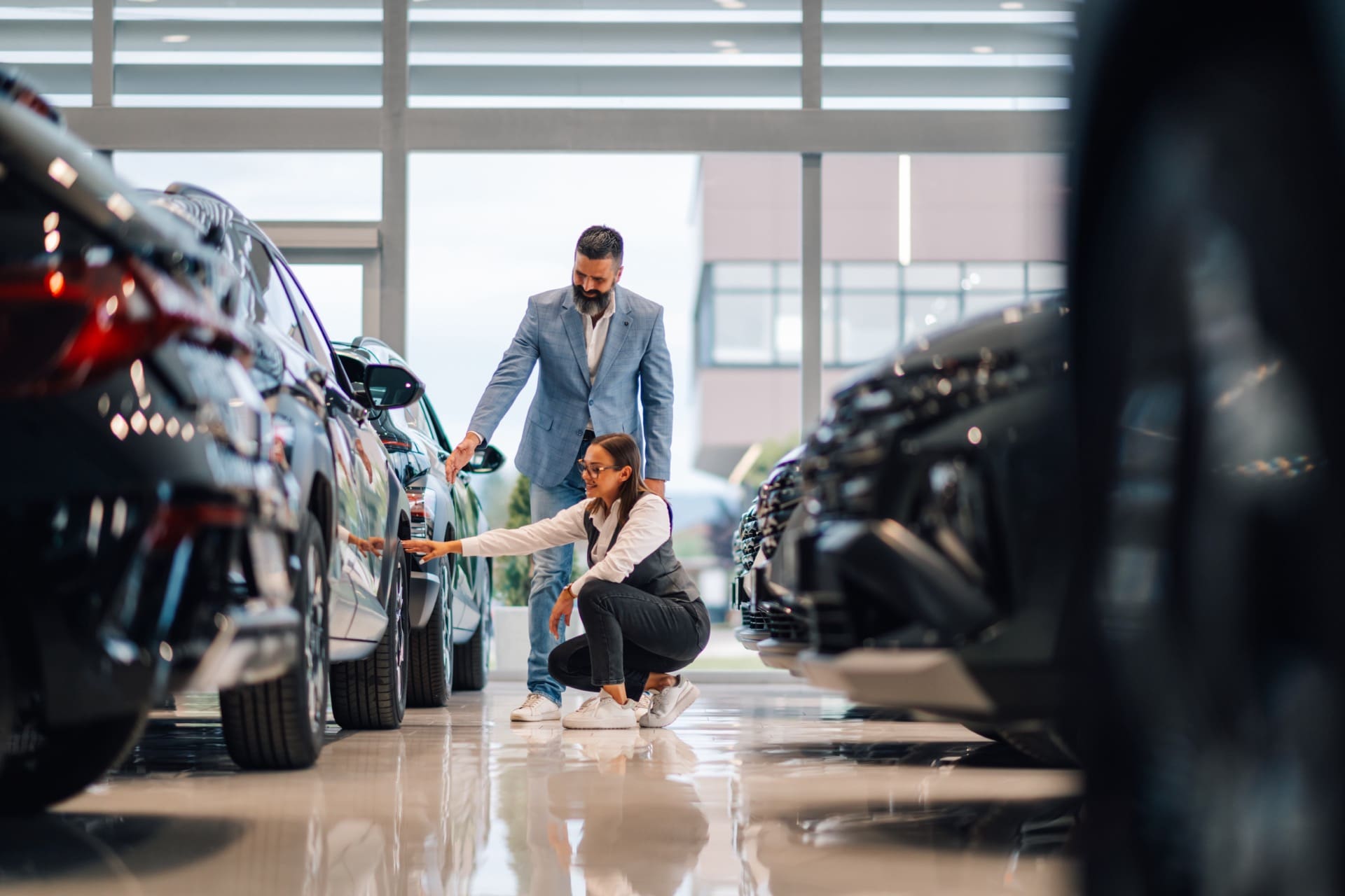 Couple inspecting a vehicle at a Lancaster PA car dealership showroom