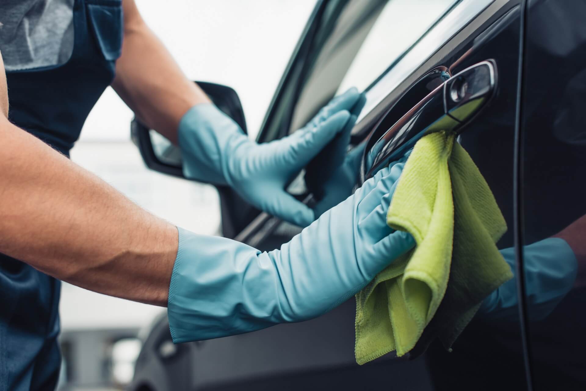 Technician performing mobile car detailing on a vehicle door in Lancaster PA