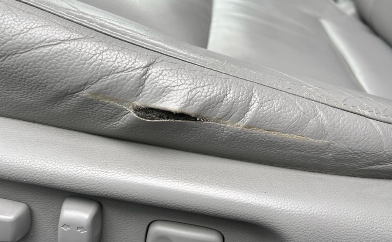 Torn leather car seat before leather repair in York PA